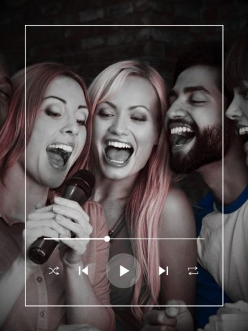 Four friends singing karaoke together.